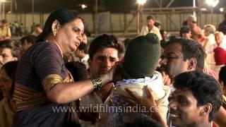 Force feeding raw fish to a baby in Hyderabad India