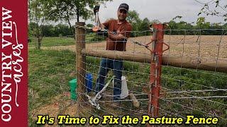 Installing the Livestock Fence over where the old trash pit was filled in.