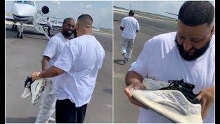 Kanye West Gives DJ Khaled Unreleased Yeezys Off His Feet At Airport