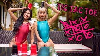 Two Cute Girls in One Piece Racing Swimsuit playing Tic Tac Toe