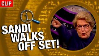 QI  Sandi Walks Off Set