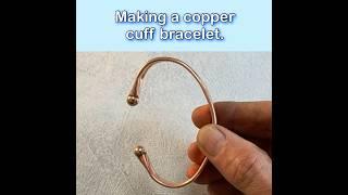 Making a copper cuff bracelet with bronze ball bearing ends.