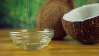 Pouring natural coconut oil into a glass bowl placed on a wood...  Indian Stock Footage  Knot9