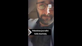 Palestinian journalist holds baby killed in Israeli strike