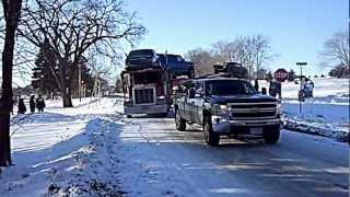Chevy Silverado DMAX pulling a jackknifed Semi-Trailer hauling cars out of a ditch.