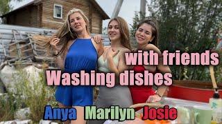 Washing dishes with friends in country house  in sheer bra