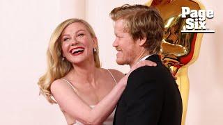 Kirsten Dunst trips over giant Oscar statue while walking 2024 red carpet with husband Jesse Plemons