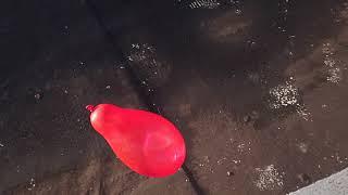 Ultra slow mo water balloon popping on the roof