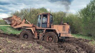 Tractor stuck in deep mud Driving off-road on heavy equipment
