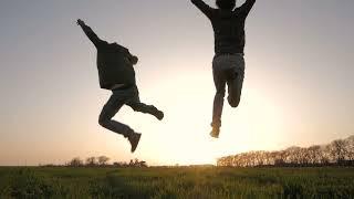 Silhouette of Two Young People Running in the Fields Free Video