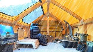 COZY CAMP WITH SKYLIGHT TENT. ALONE IN THE WINTER RAIN