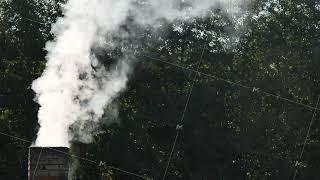 White smoke from the chimney of the village house.