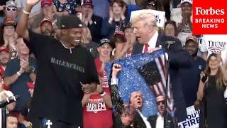 JUST IN Trump Brings Artist Artlanta On Stage To Sign Work Depicting Fight Fight Fight Moment