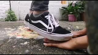 2 Girls in sneakers hand trampling and crushing food and fruit. with adidas superstars and vans