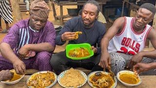 fisherwoman prepared banga soup with lot of different fish and Eba - Nigeria native soup