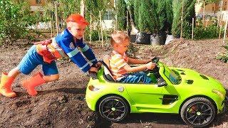 Nikita ride on childrens car and stuck in the ground Vlad tows on the tractor