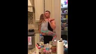 Dad Dances with Daughter in Kitchen