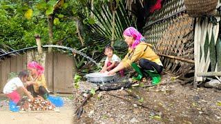 After selling cassava mother and daughter used the money to buy plastic pipes to bring water home.